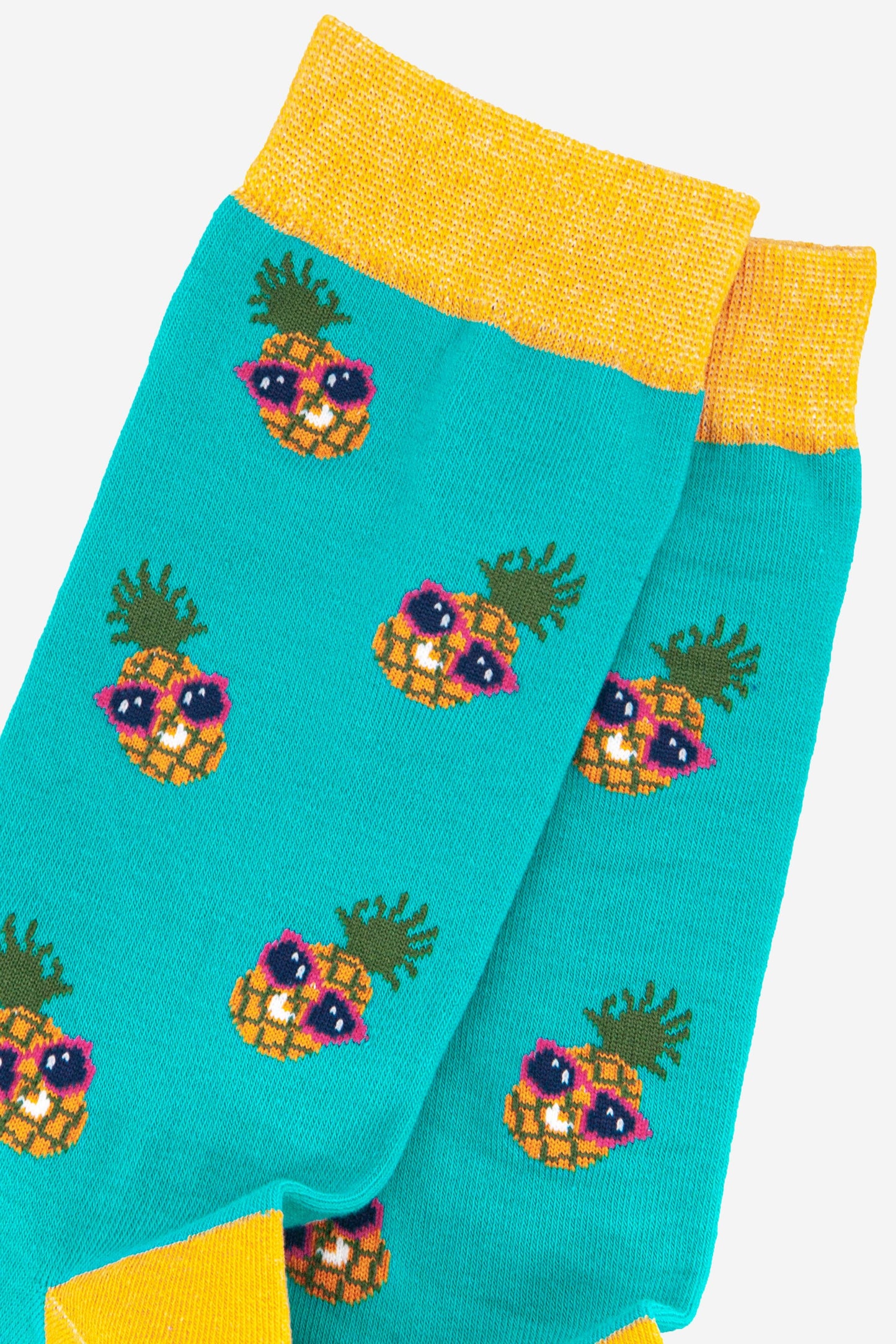 close up of the sunglass wearing pineapples on these mens bamboo socks