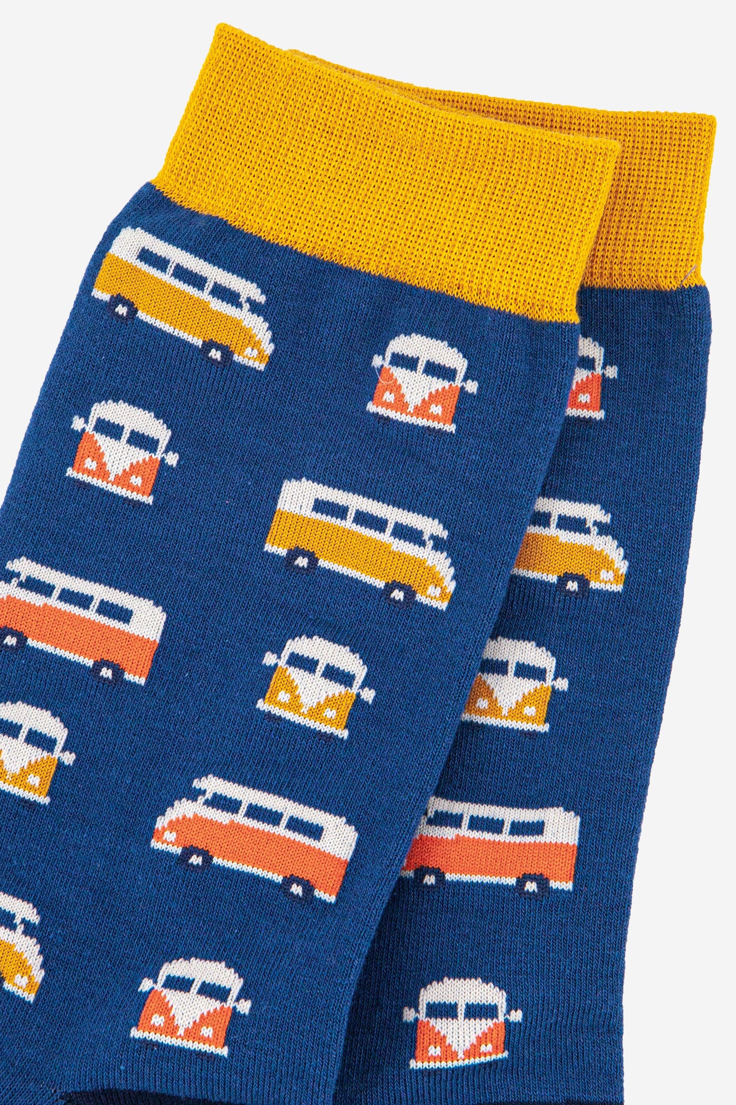 close up of the campervan pattern on the bamboo socks showing yellow and orange vintage style campevans