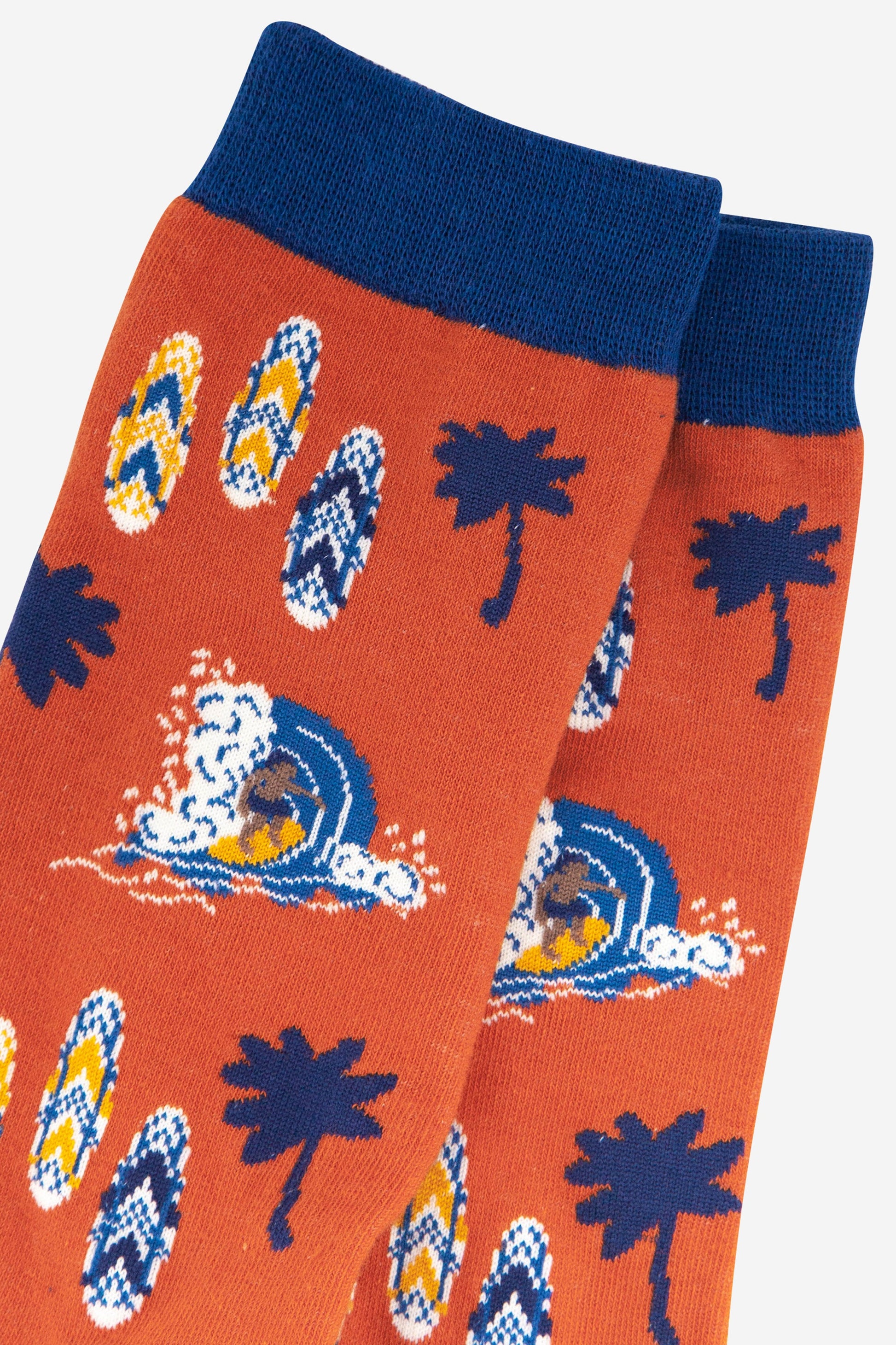 close up of the surfer and surf board pattern on the mens bamboo socks