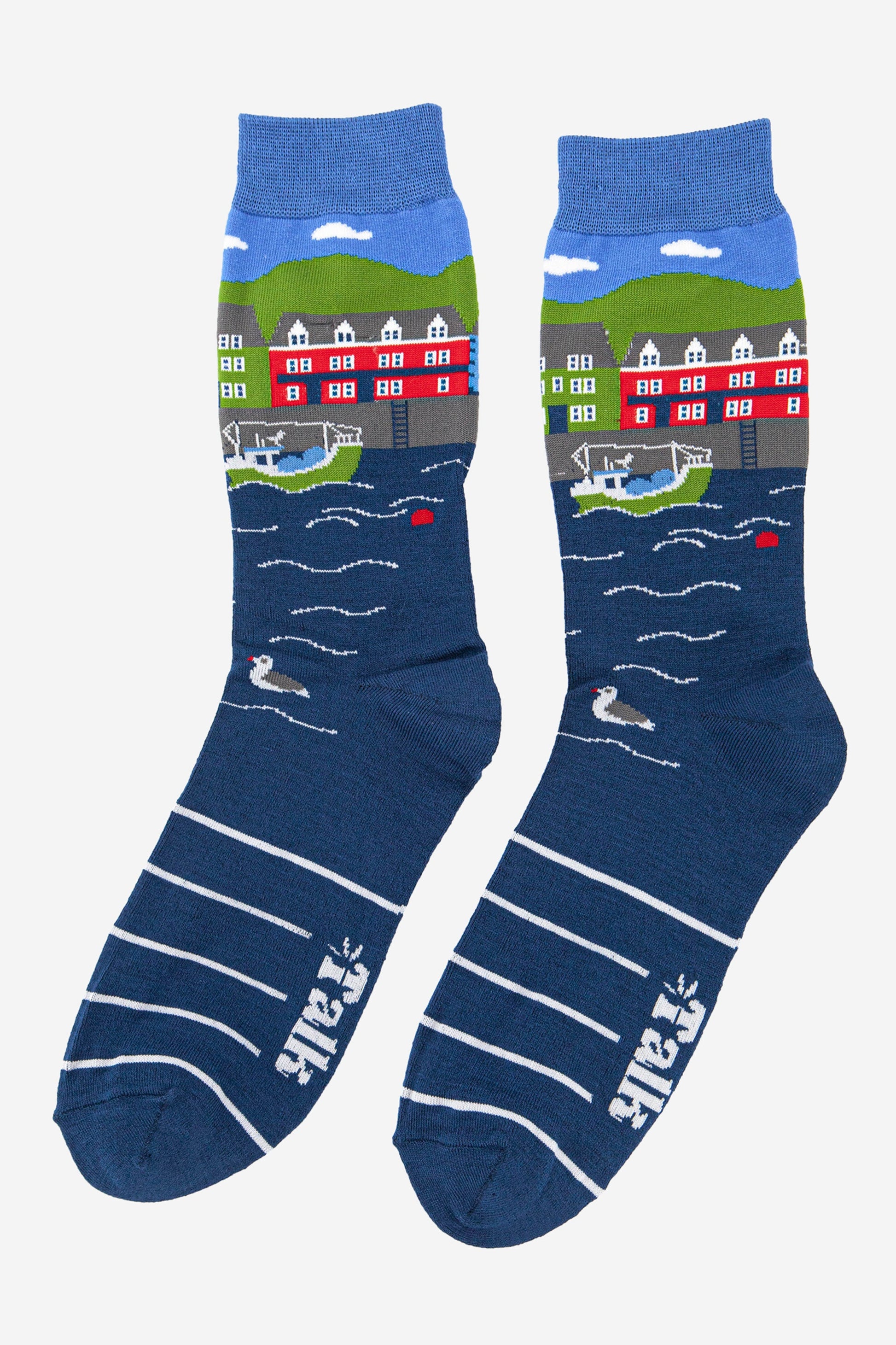 mens fishing village scene bamboo socks in blue, green and red, featuring a harbour setting with a fishing boat and seagulls