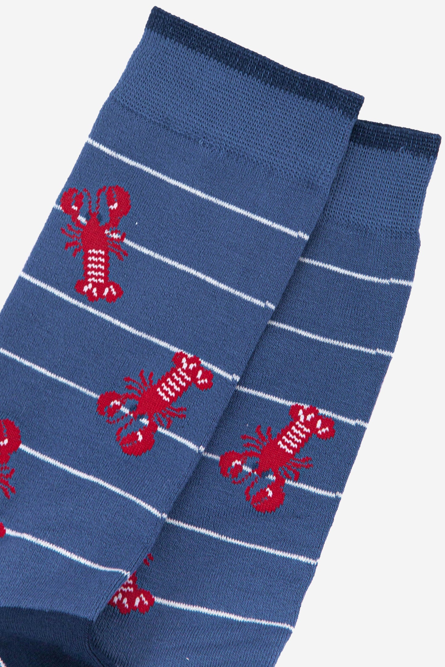 close up of the red lobster pattern on the mens blue bamboo socks