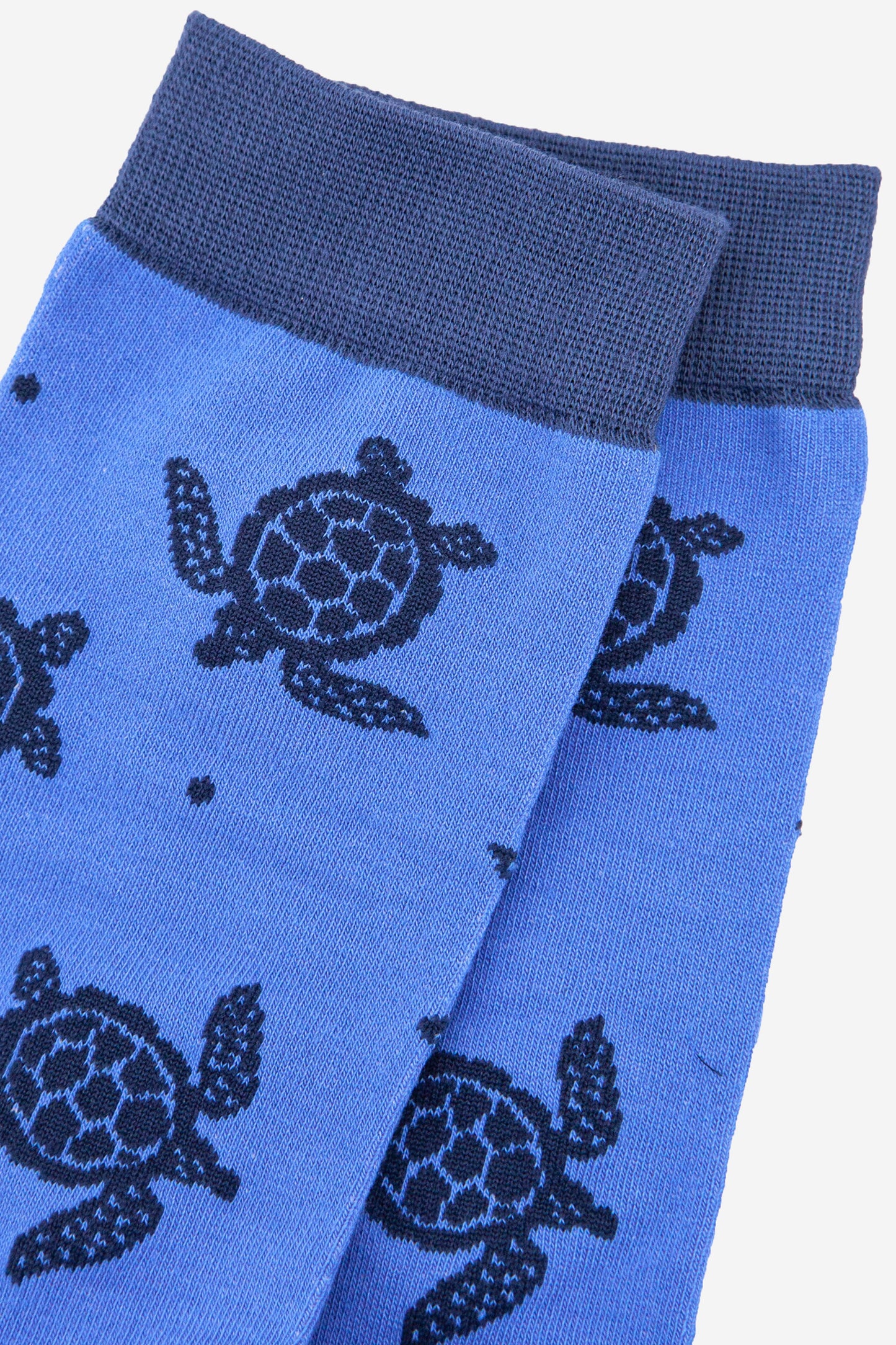 close up of the sea turtle pattern on the mens blue dress socks