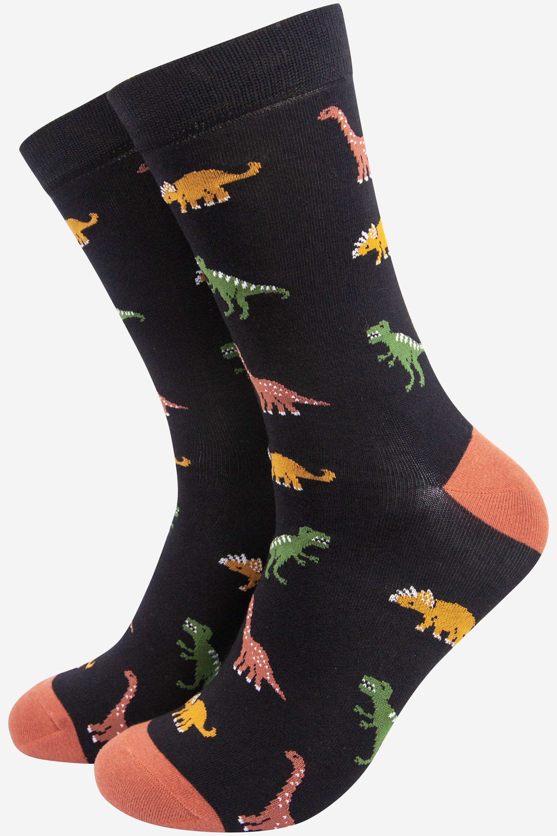 black bamboo socks with an all over patten of assorted dinosaurs in multiple colours, green, orange and yellow
