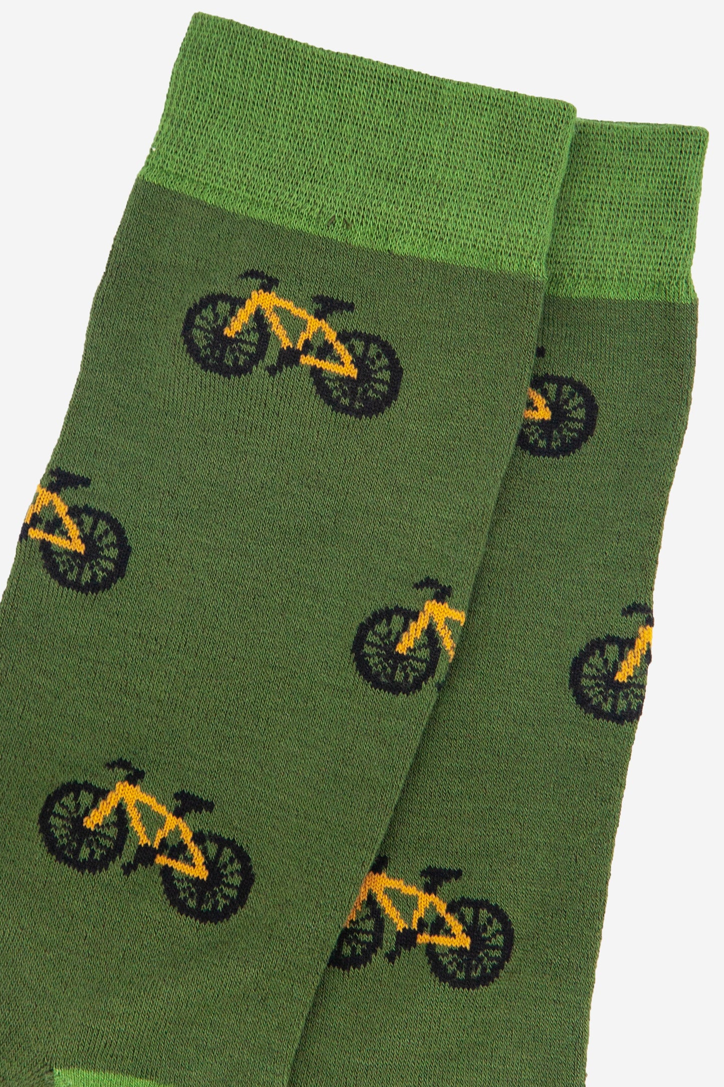close up of the yellow mountain bike design on the green bamboo socks