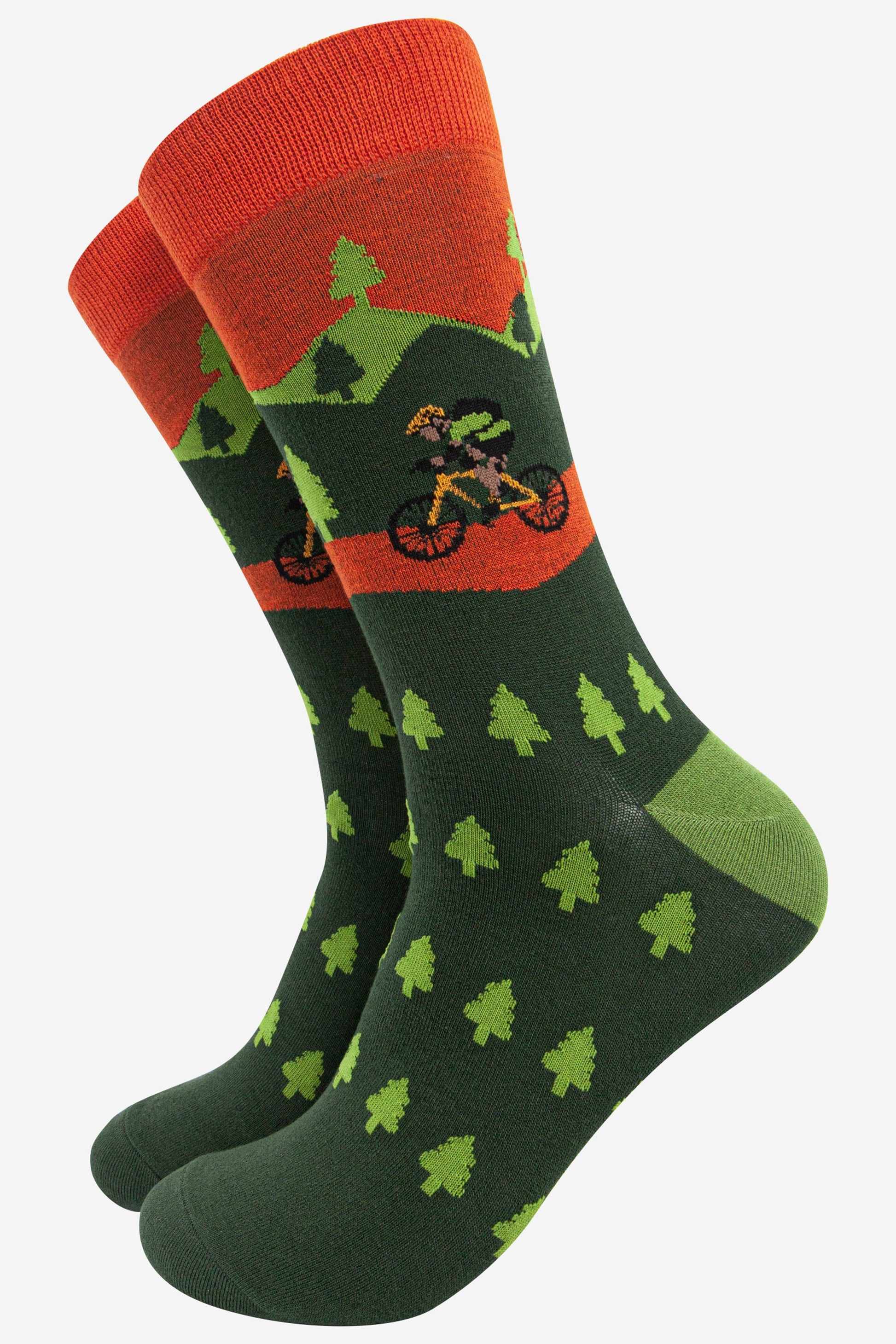 green and orange bamboo socks featuring a forest of trees and a person on a mountain bike