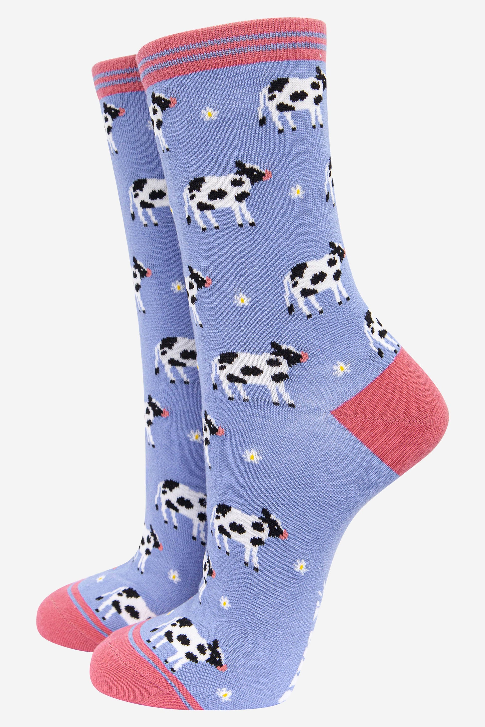 lilac and pink bamboo socks with an all over pattern of black and white cows and daisy flowers