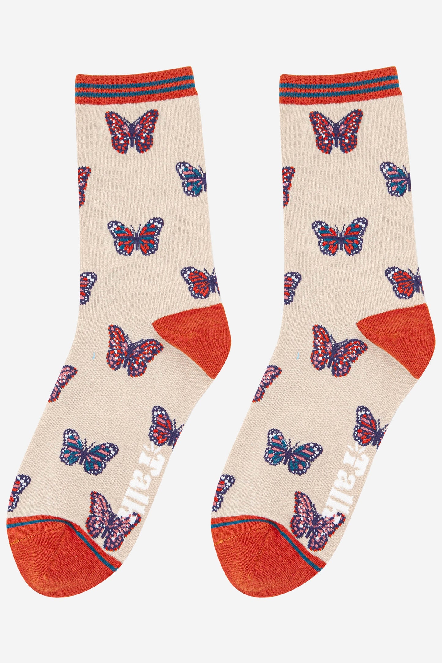 womens cream coloured ankle socks with burnt orange heel, toe and cuff with an all over butterfly print pattern