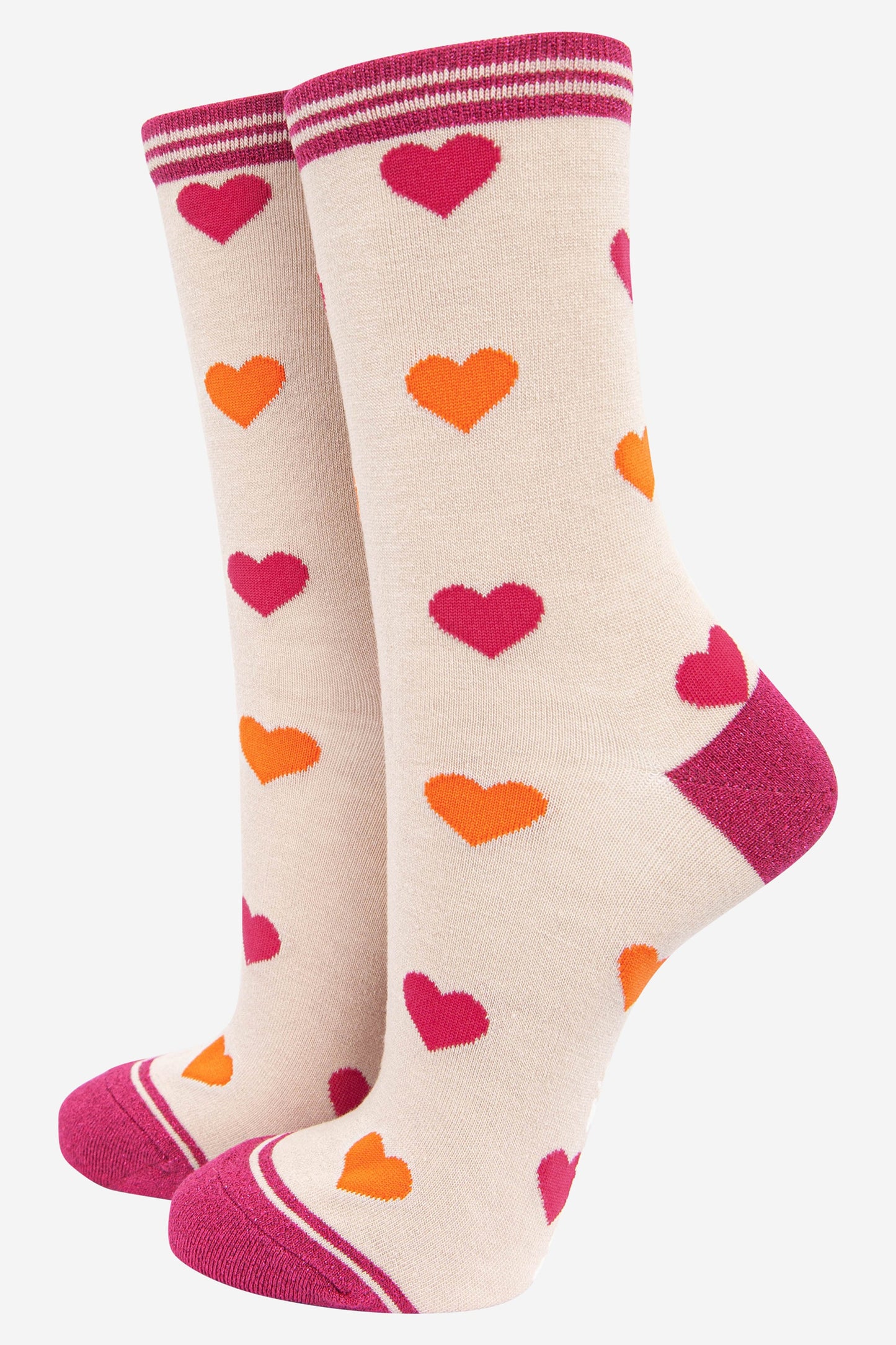 cream ankle socks with a glittery pink heel, toe and cuff with an all over pattern of pink and orange love hearts
