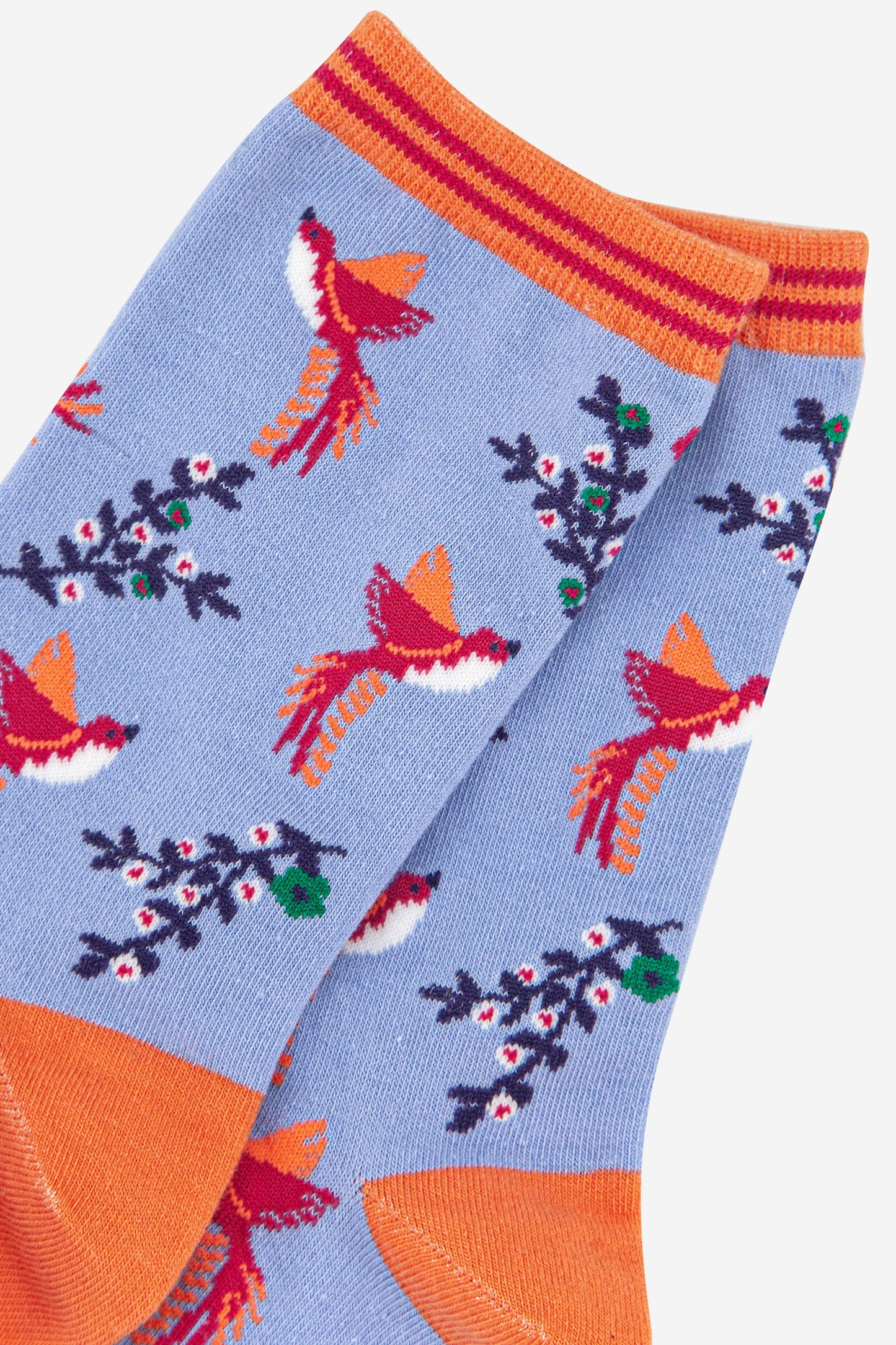 close up of the pink hummingbird print on the bamboo ankle socks, a close up of the orange and pink stiped cuff