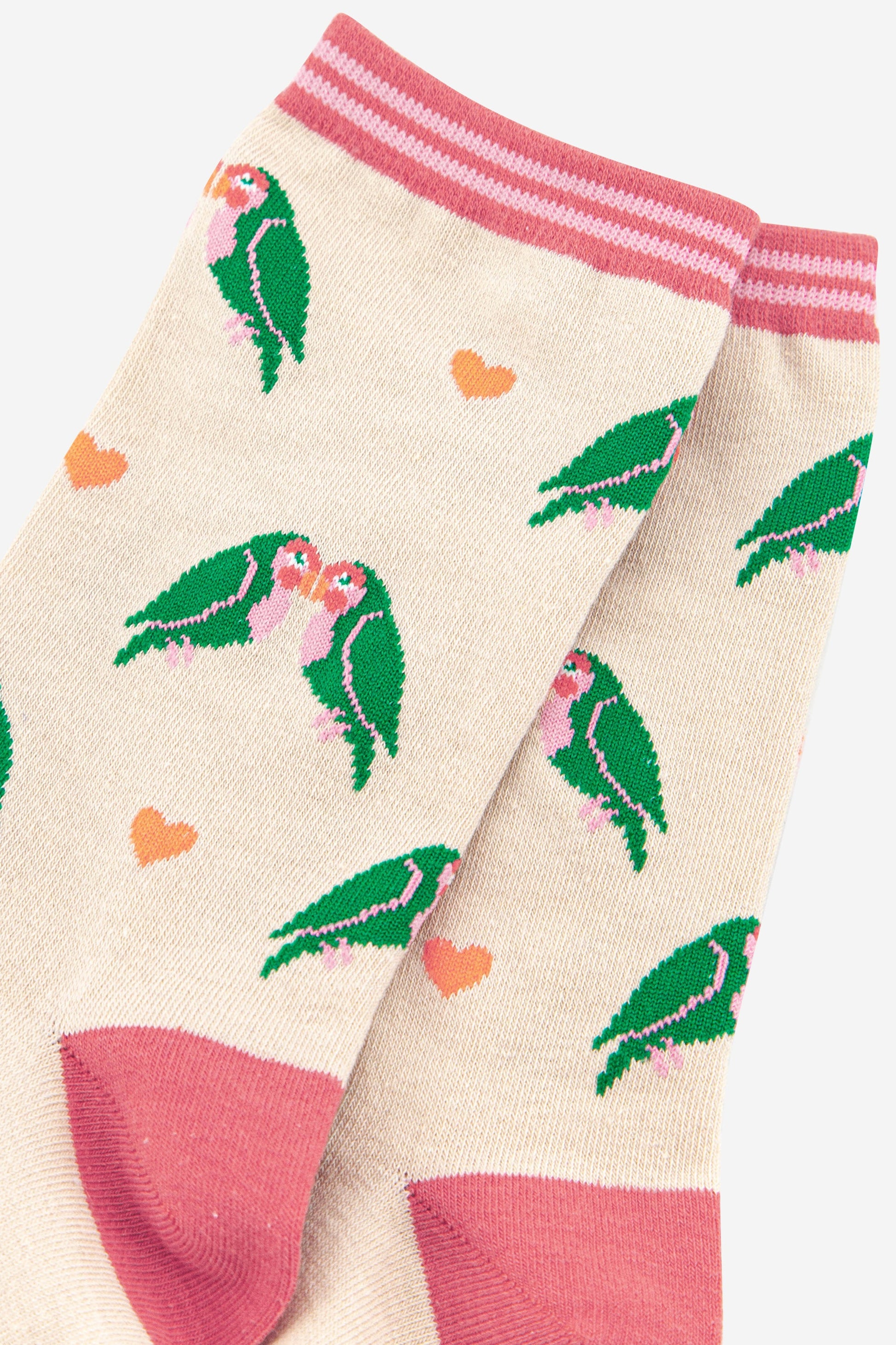 close up of the green love bird patten and pink love hearts on these bamboo ankle socks