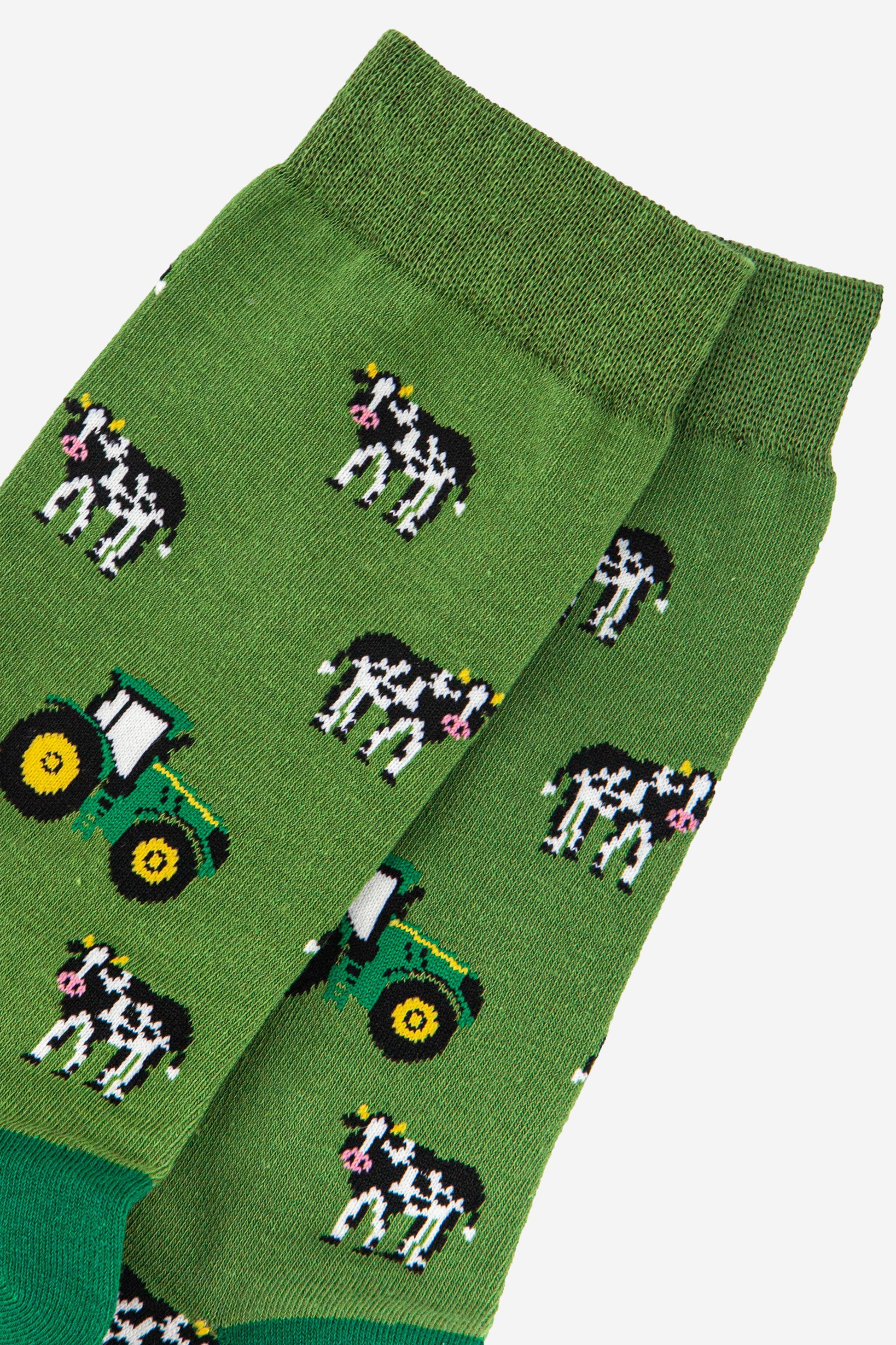 close up of the green tractors and black and white cow pattern on the bamboo socks