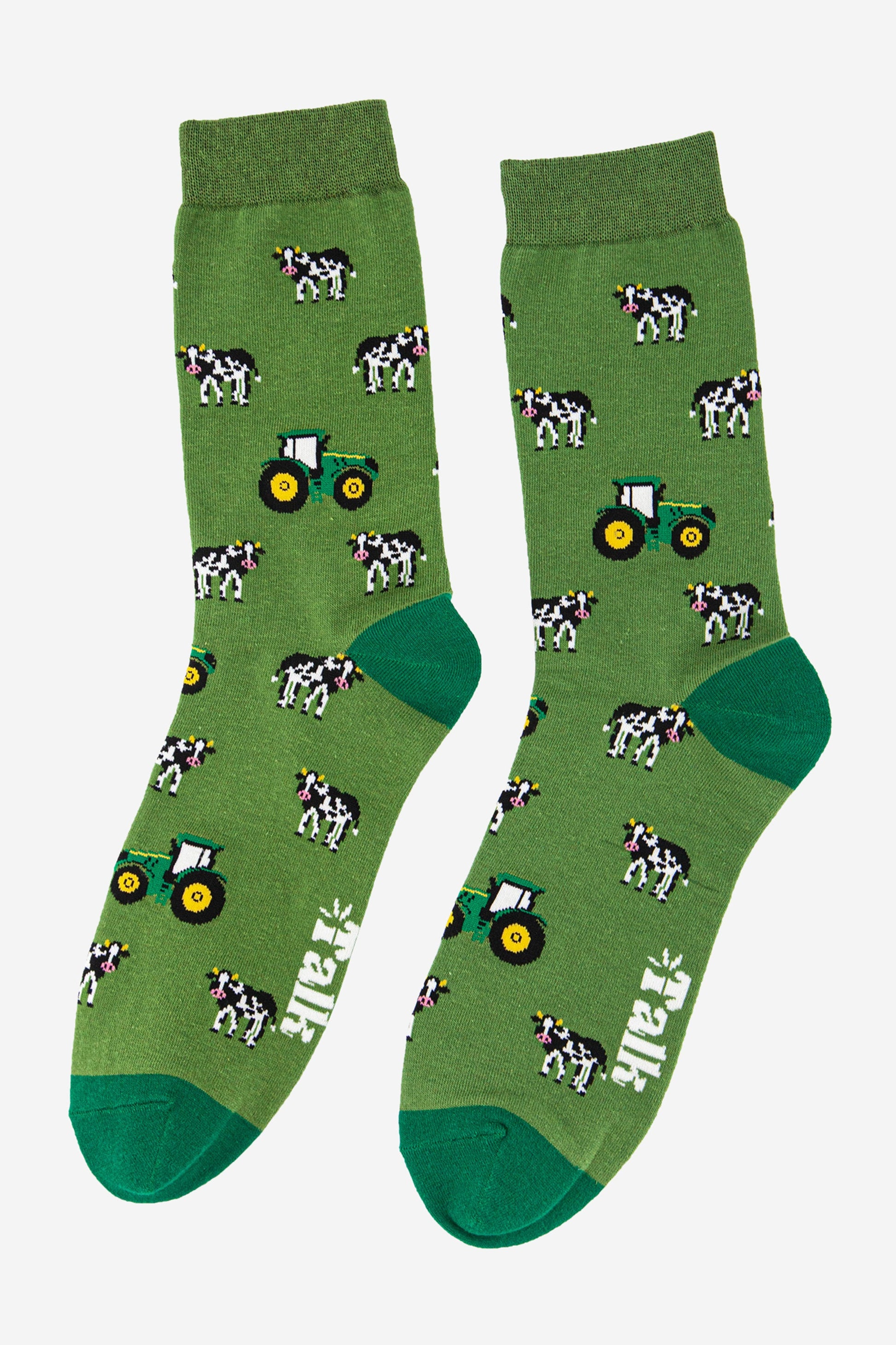 green novelty socks featuring a pattern of cows and tractors