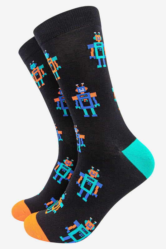 black socks with an all over pattern featuring blue and orange vintage robots with a blue heel and orange toe