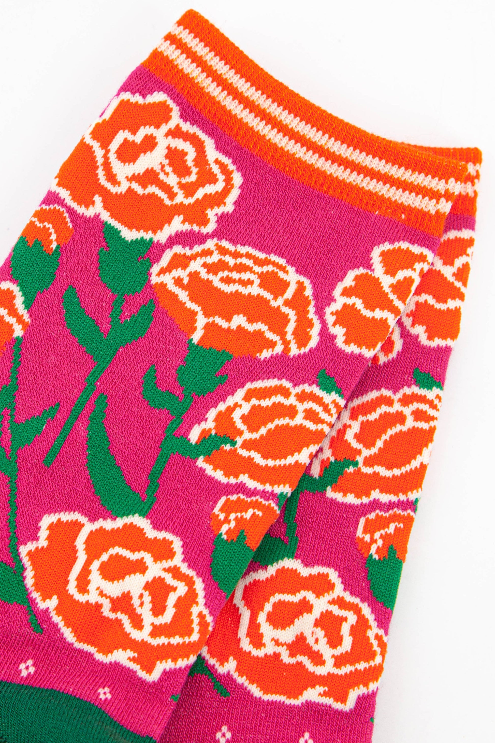 close up of the carnation floral design on the ankle of the socks