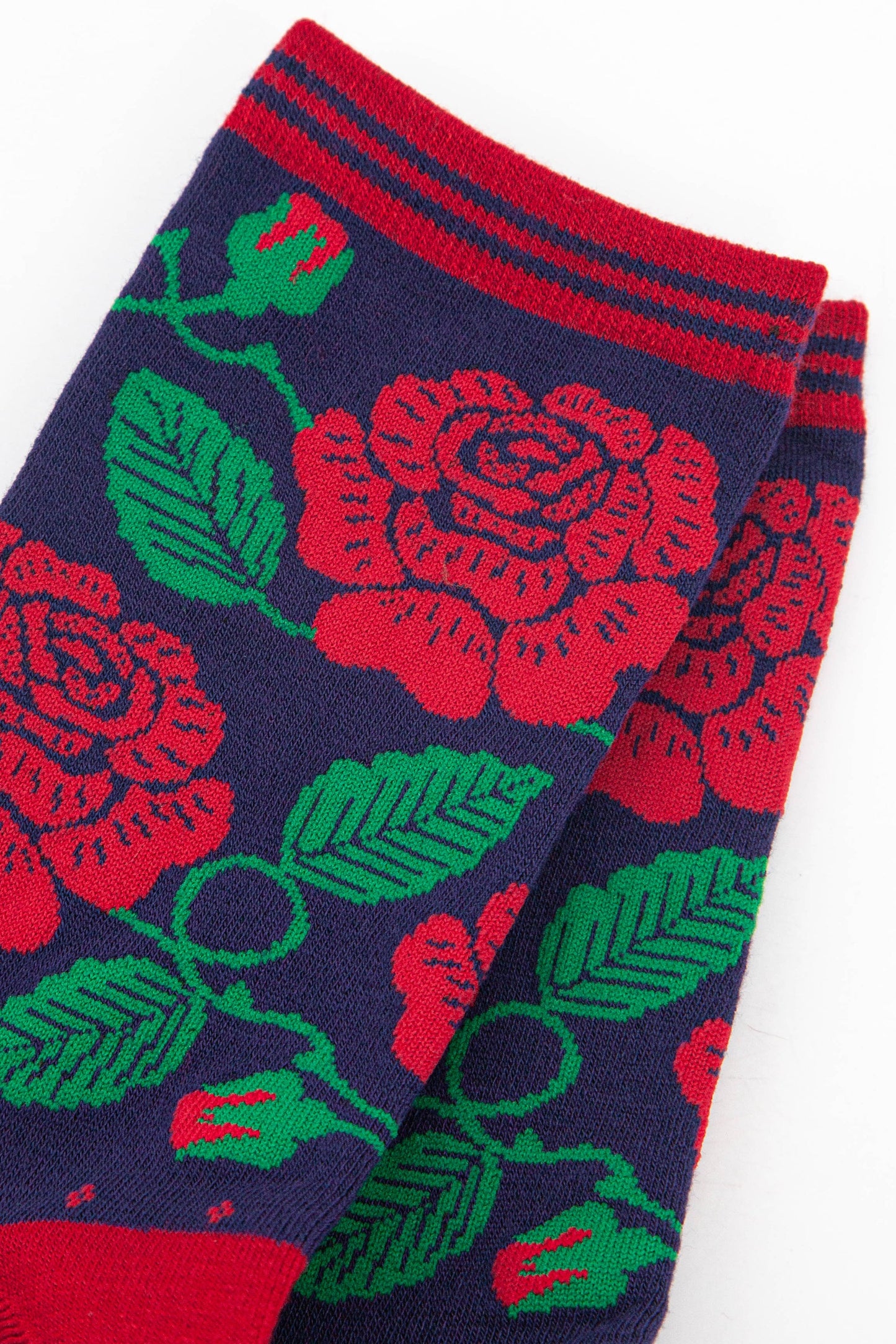 close up of the red rose pattern on the ankle of the socks