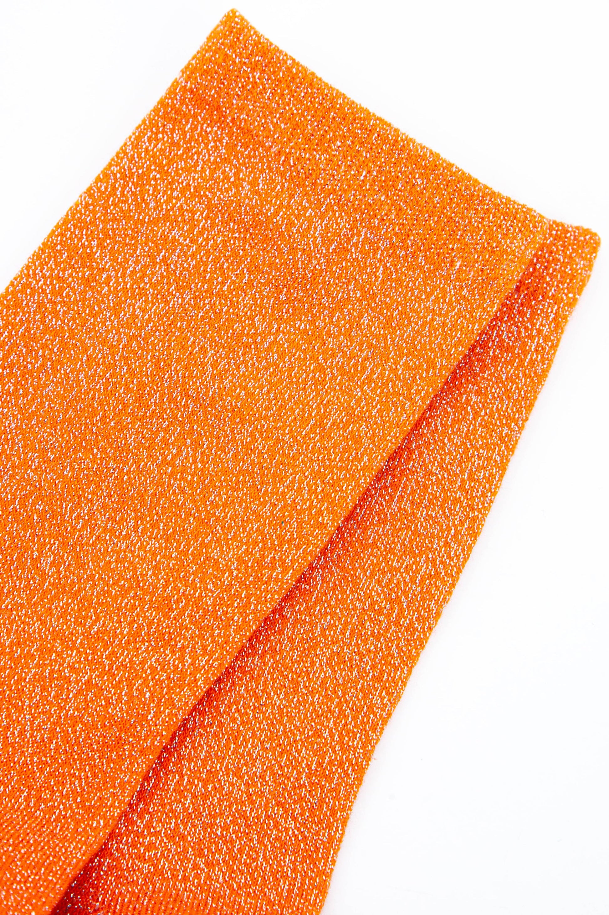 close up of the orange glitter socks showing the silver sparkly glitter material