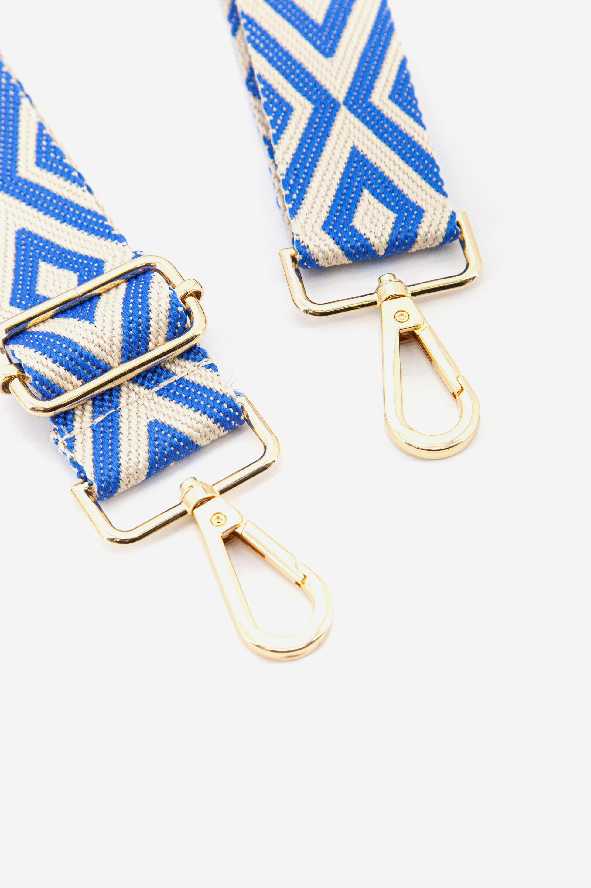 close up of the woven blue ikat pattern and gold clip on hardware