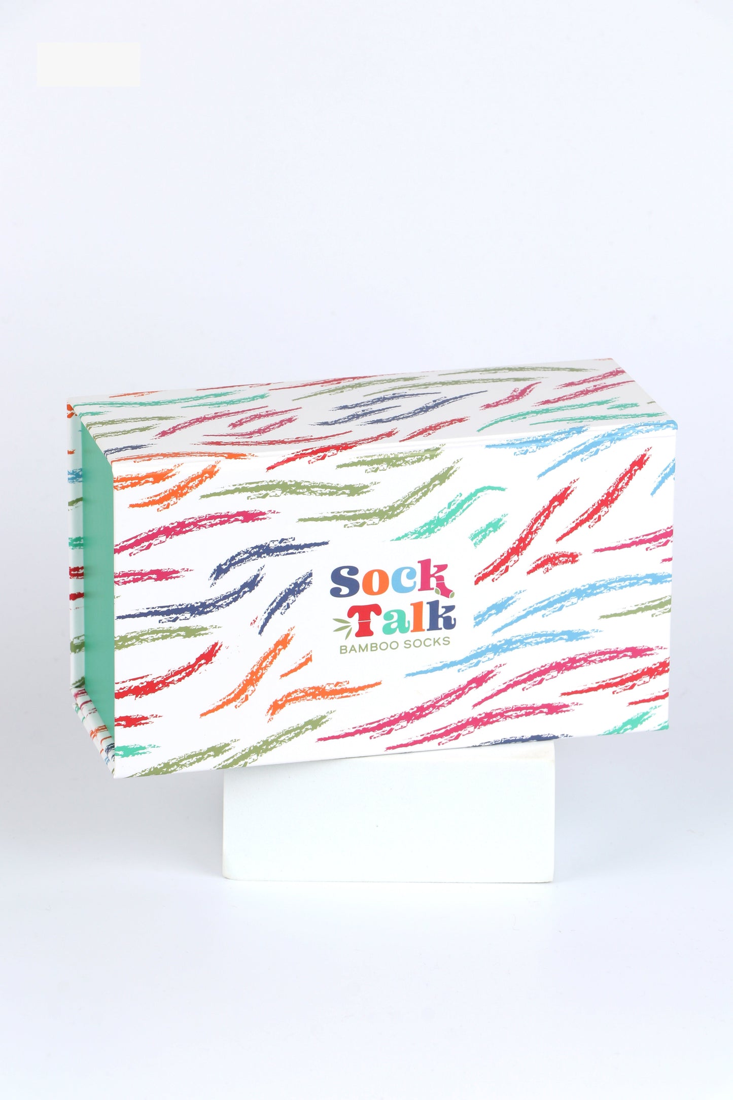 white gift box with an all over pattern of multicoloured brushstrokes 