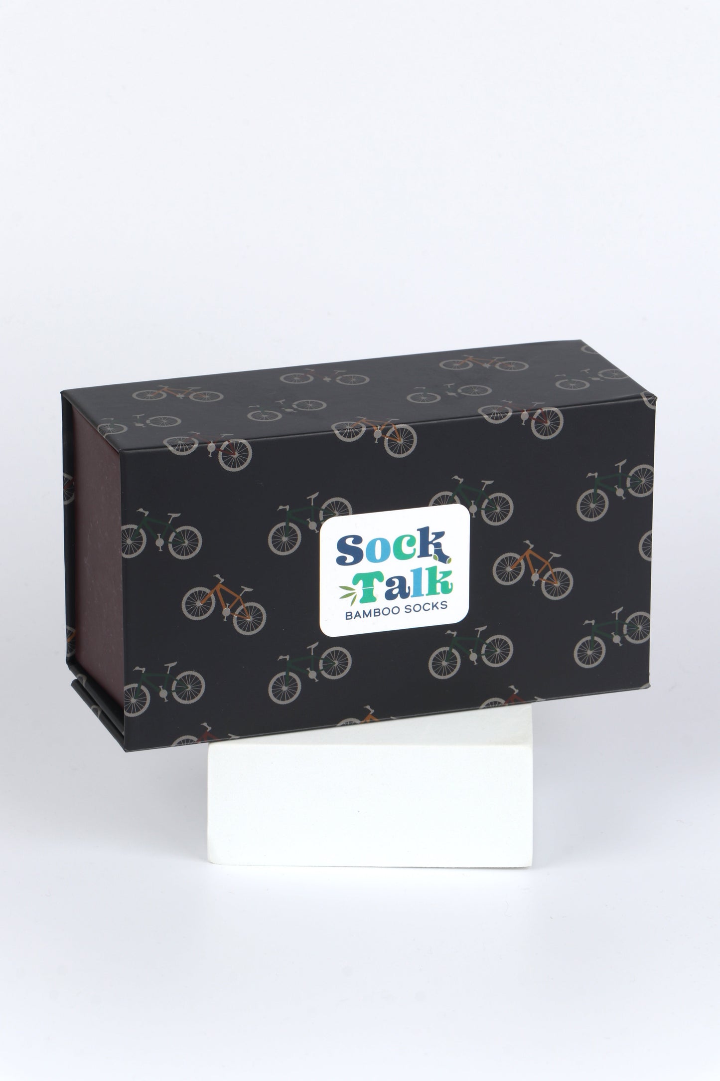 black gift box with an all over pattern of bicyles and mountain bikes in yellow and green