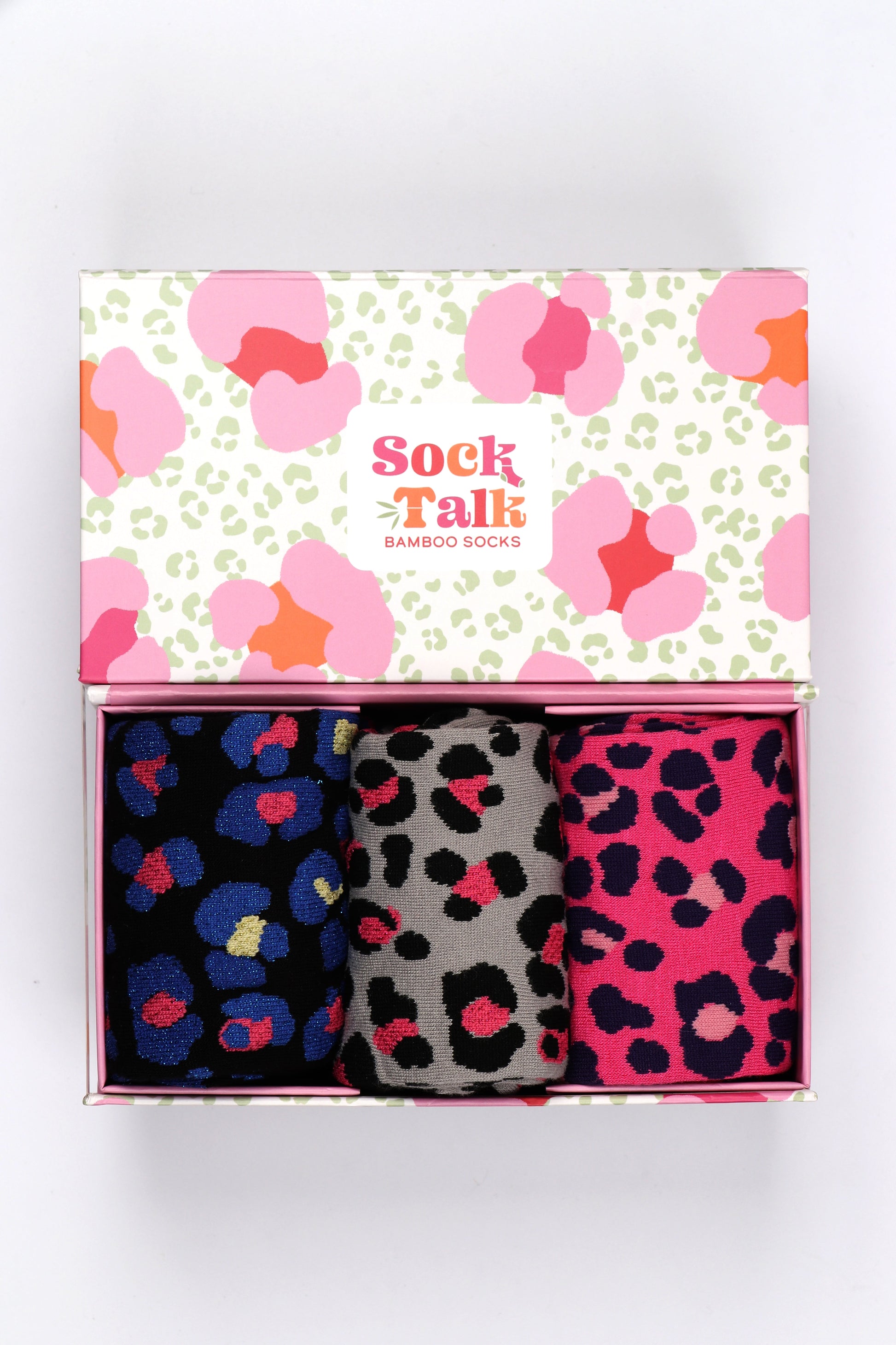three pairs of colourful leopard print bamboo socks in a matching leopard print gift box