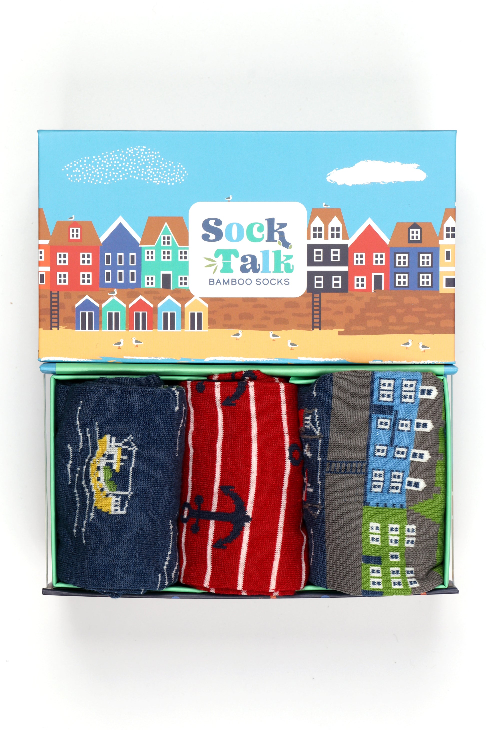 three pairs of nautical themed bamboo socks in an artistically designed gift box which looks like a seaside beach town