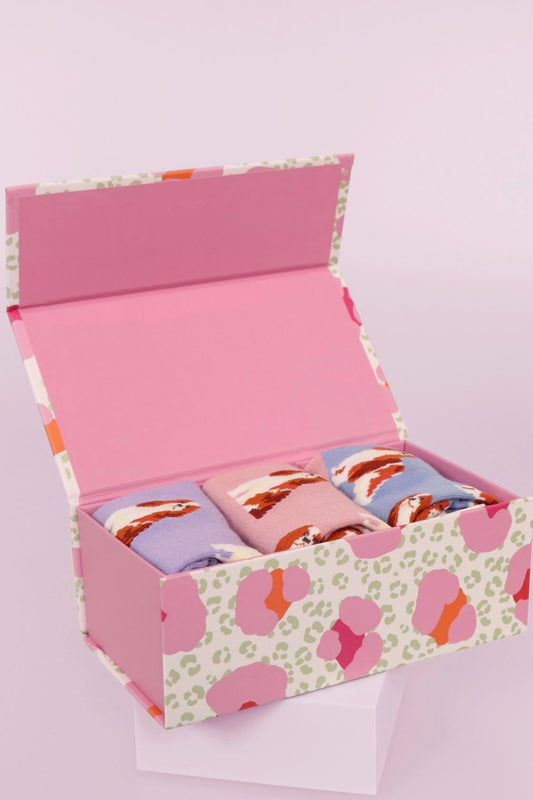A pink animal print gift box with three King Charles Spaniel Ladies Bamboo Socks