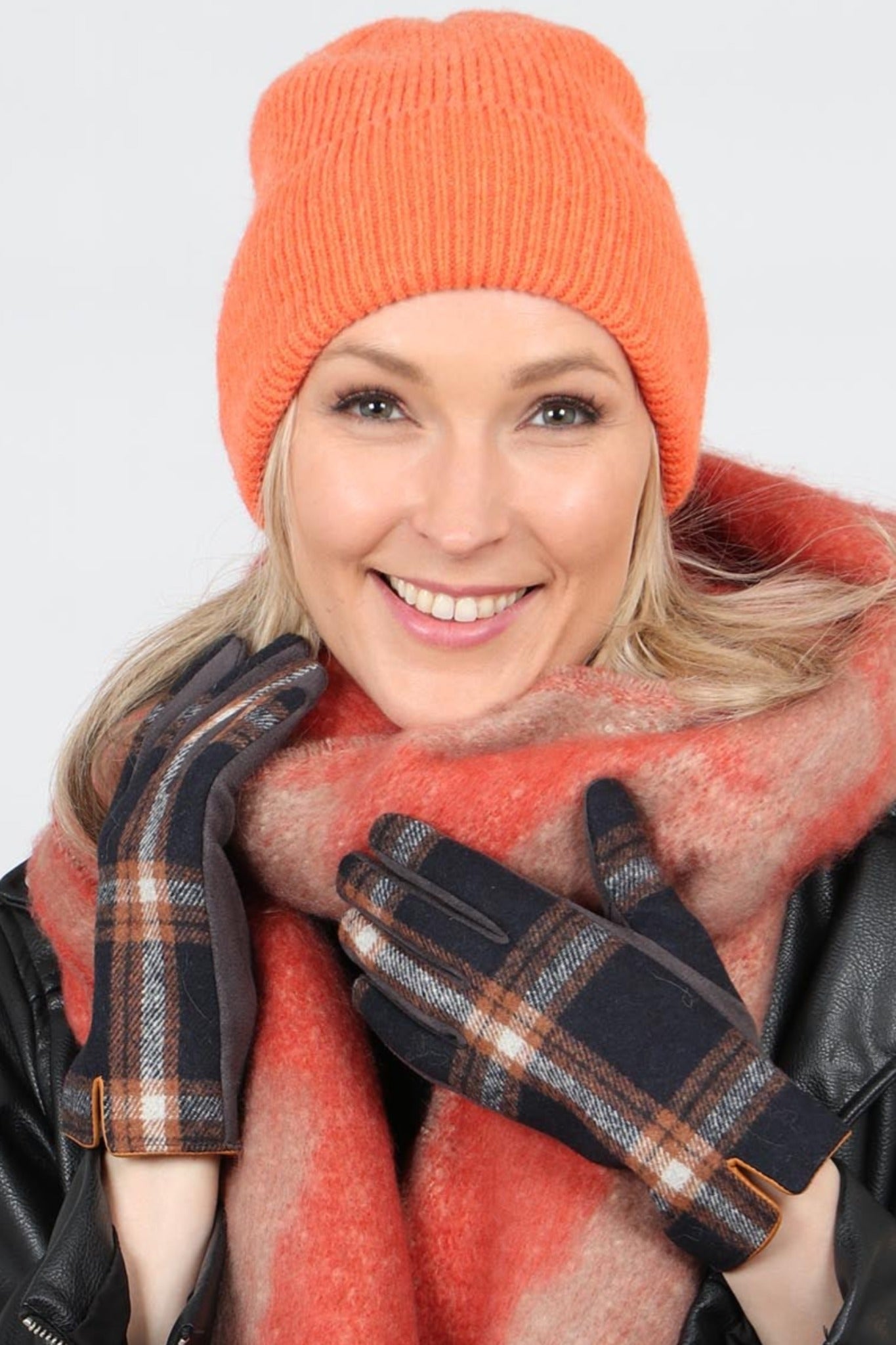 model wearing a plain orange knitted beanie hat
