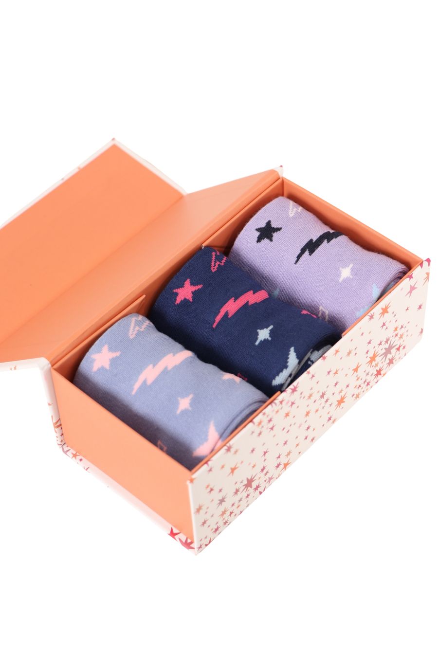 An open gift box showing three star print and lightning bolt print socks, in blue, purple and lilac