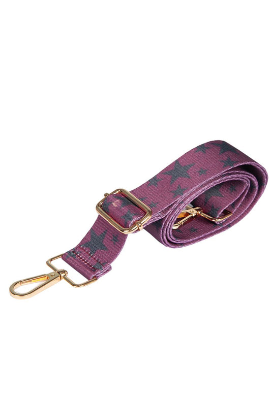 pink crossbody bag strap with a black star print pattern