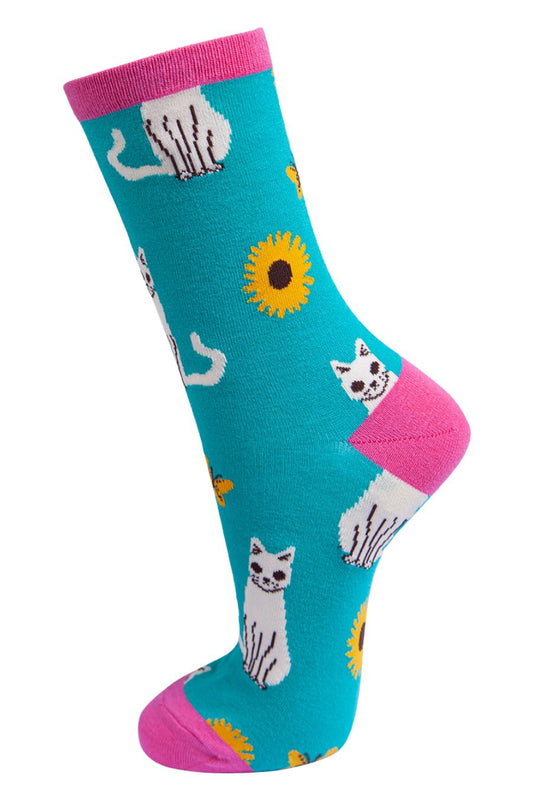 teal, pink ankle socks with white cats and yellow sunflowers