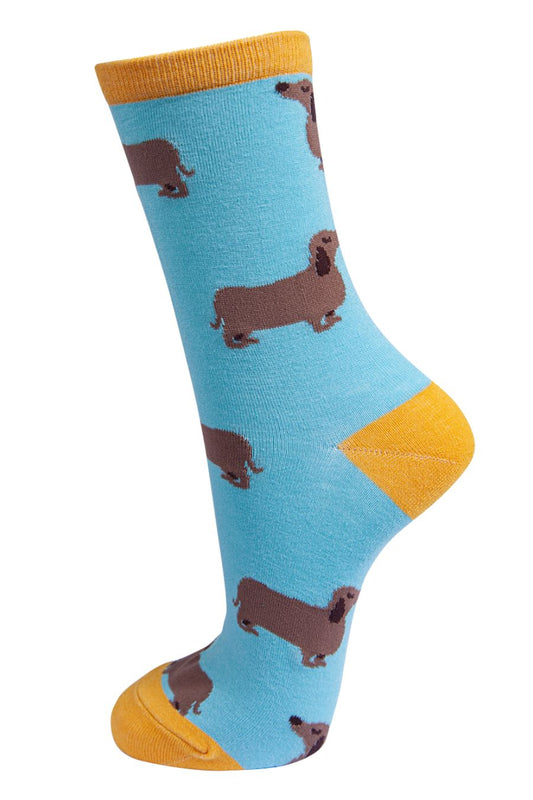 blue and yellow bamboo ankle socks with sausage dogs on them