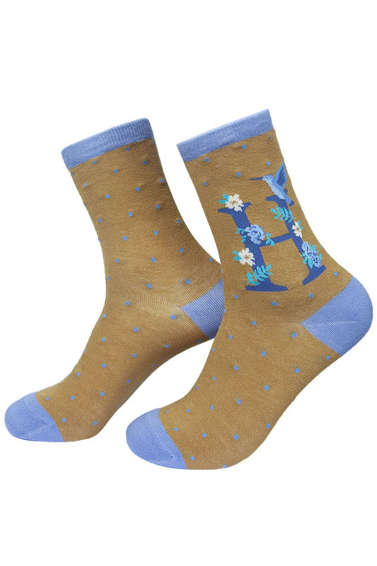 mustard yellow, blue ankle socks with a letter H and a hummingbird