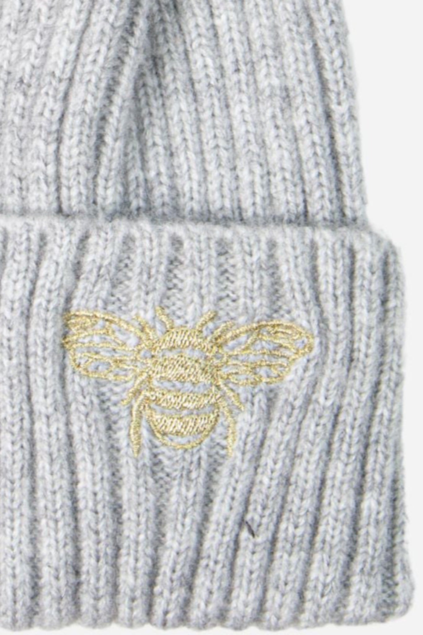 close up of the embroidred bee motif