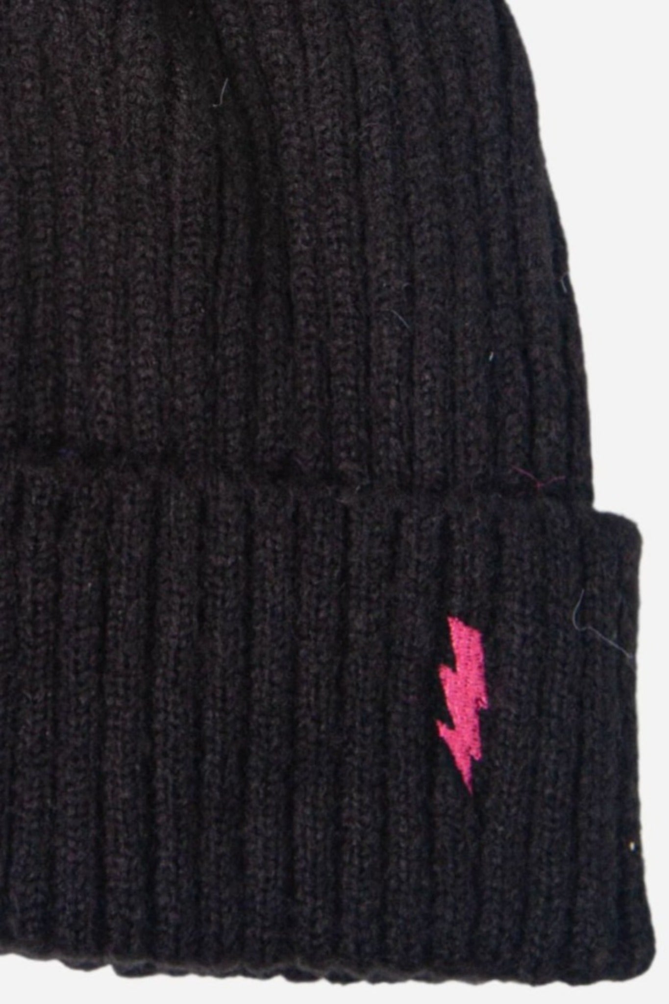 close up of the ribbed knitted material and fuchsia pink lightning bolt