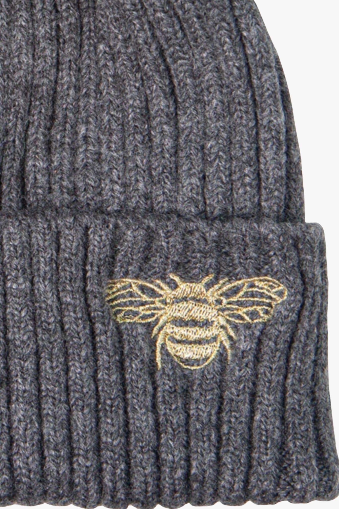 close up of the emboridered bee and ribbed knitted fabric