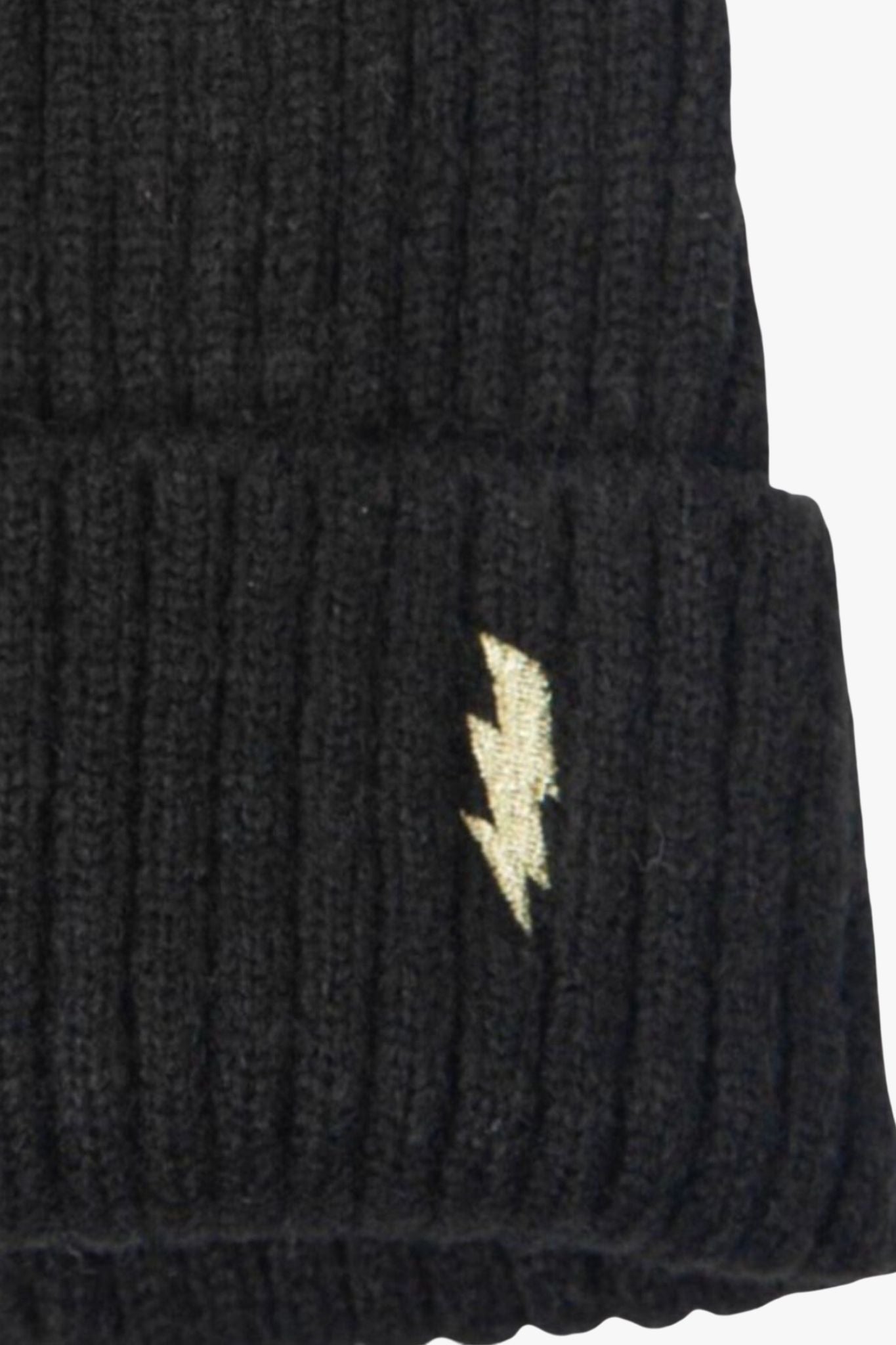 close up of the gold lightinng bolt motif and ribbed knitted material