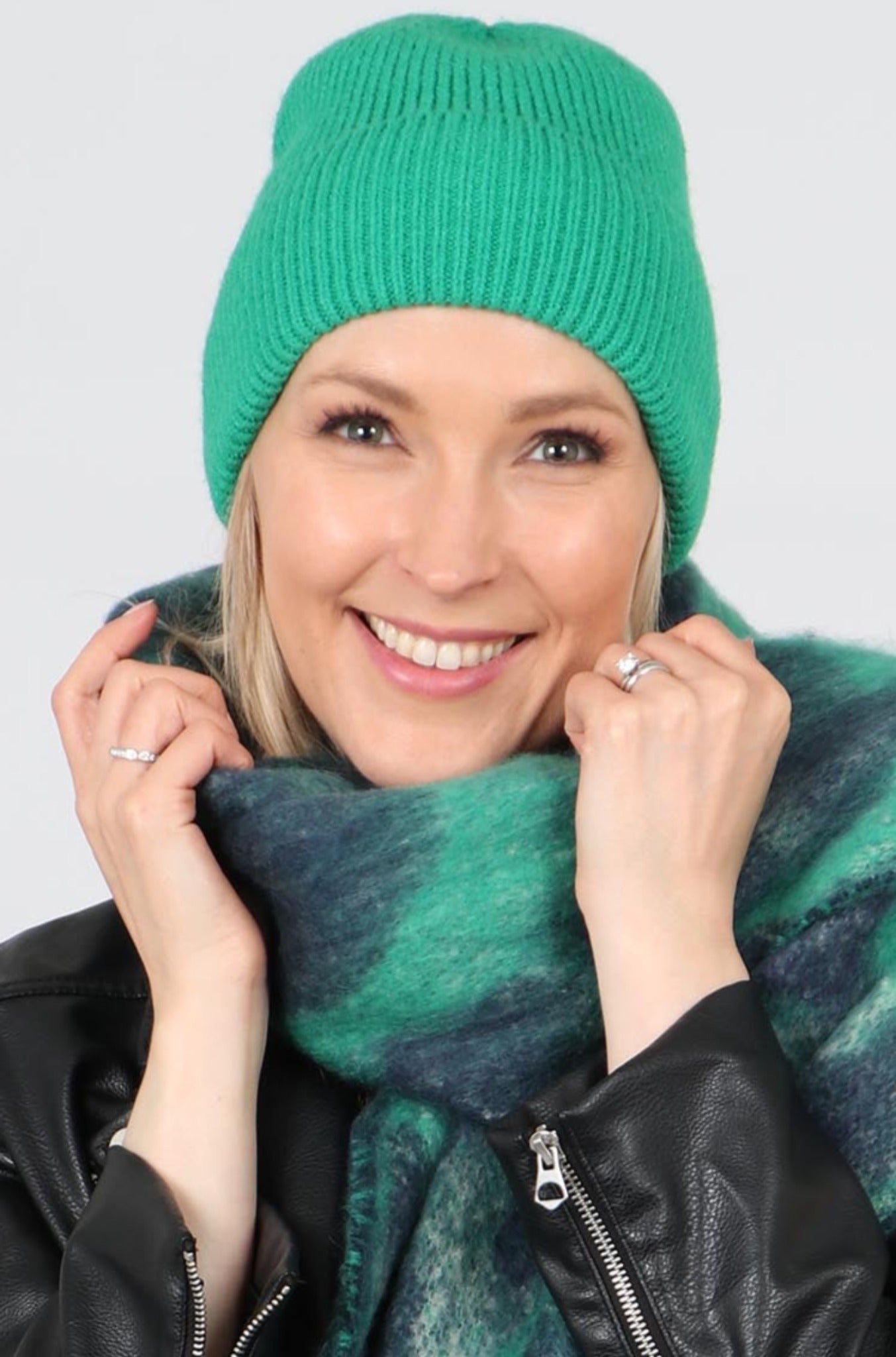 model wearing a plain vibrant green beanie hat